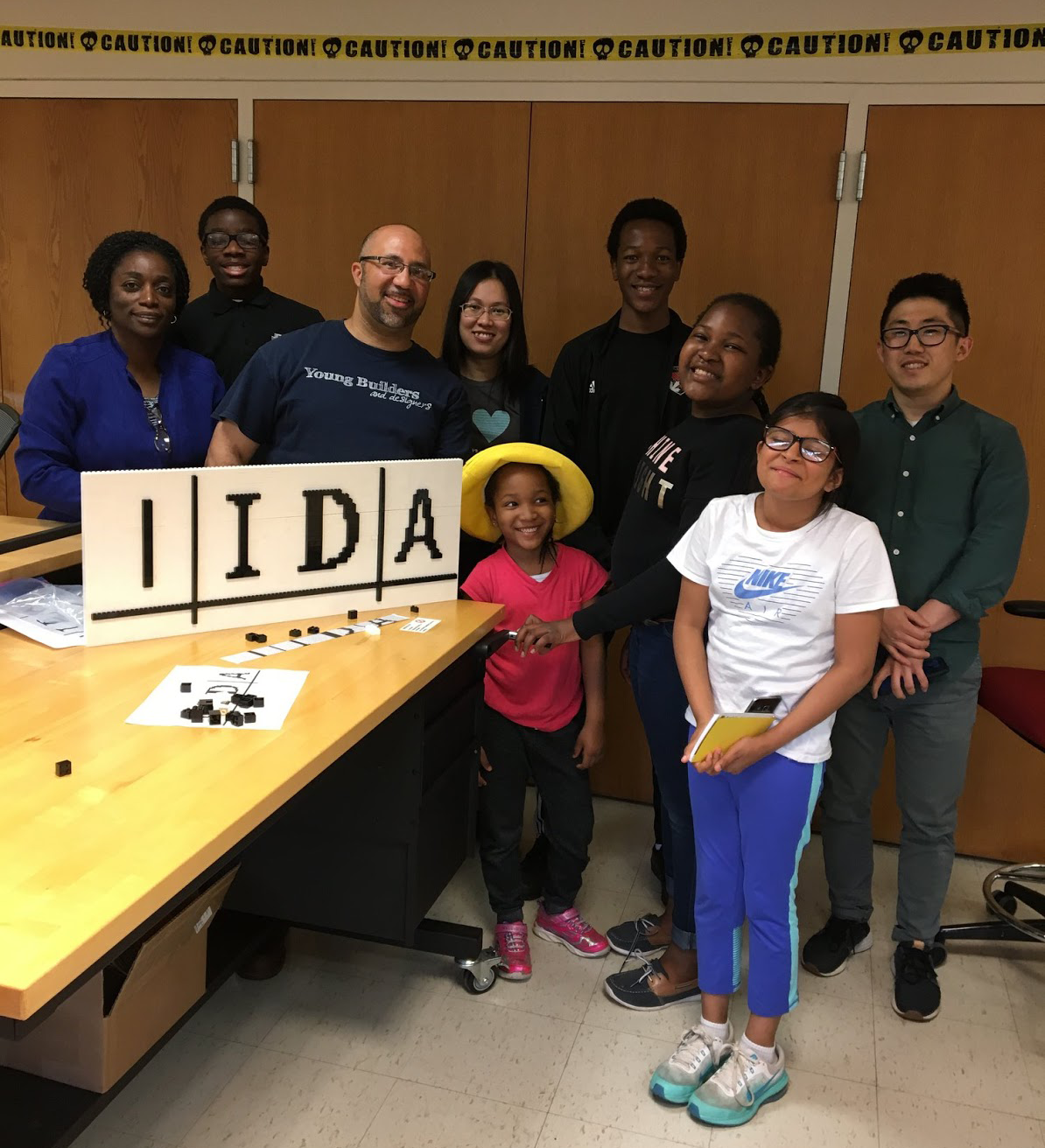 Students and instructors posing with completed IIDA logo.