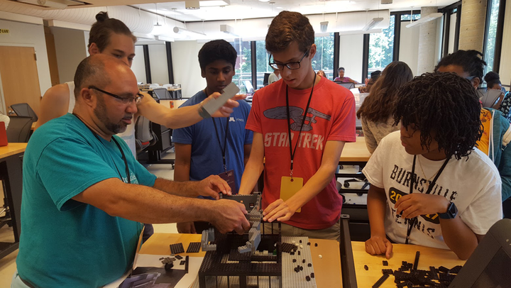 Architects and students working on a LEGO model